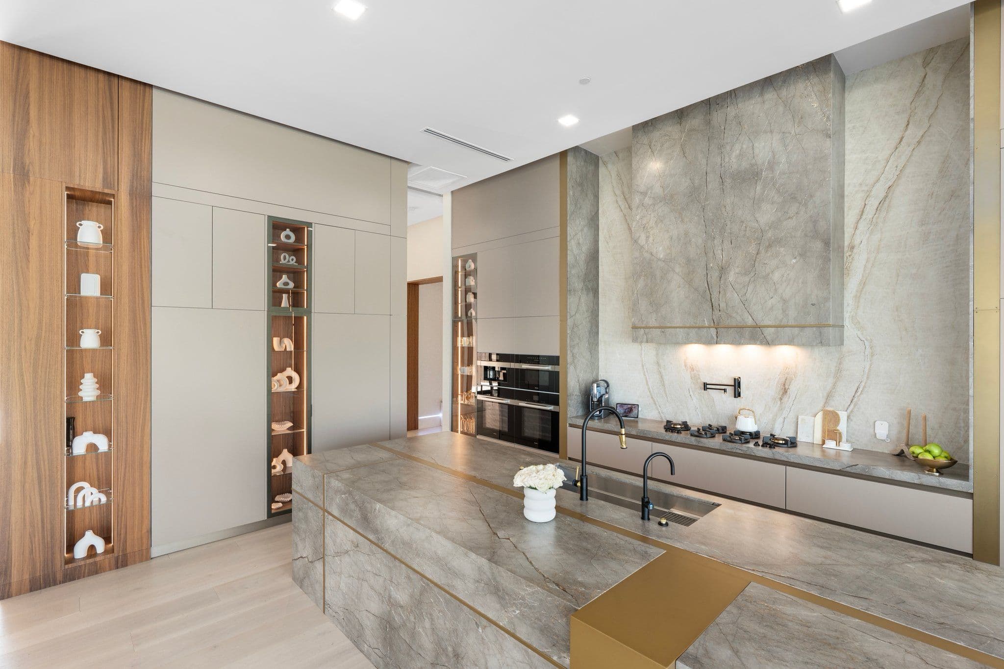 Modern kitchen with sleek stainless steel appliances and minimalist design, part of the Modern Desert Oasis collection by a premier home renovation expert.