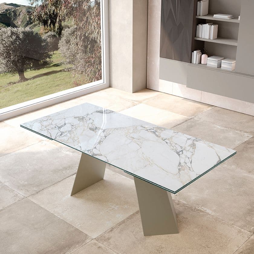 The Phoenix table has an extendable Dark Brass structure and Walnut veneered top